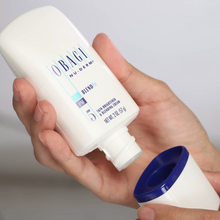 Load image into Gallery viewer, Woman holding Obagi Nu-Derm BlendFx by hoodermatology.com